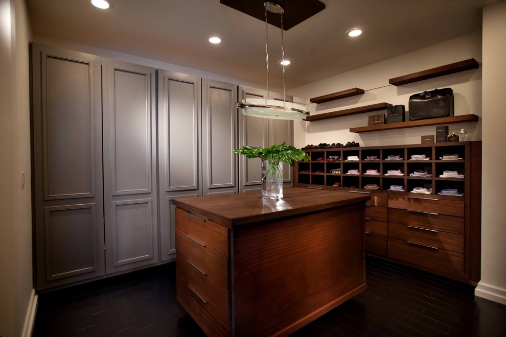 Photo of a contemporary storage and wardrobe in Orlando with grey cabinets and dark hardwood floors.