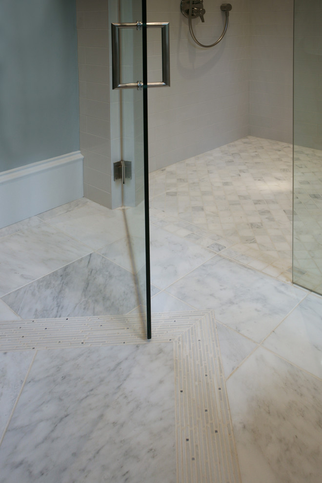 Mid-sized contemporary 3/4 bathroom in Atlanta with an undermount sink, recessed-panel cabinets, white cabinets, limestone benchtops, an alcove shower, a one-piece toilet, white tile, ceramic tile, grey walls and marble floors.