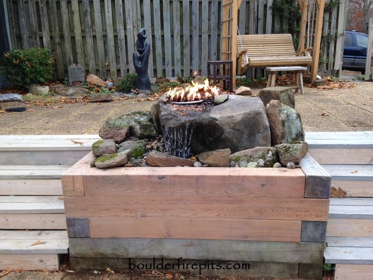 This is an example of a country garden in Other with a fire feature and brick pavers.