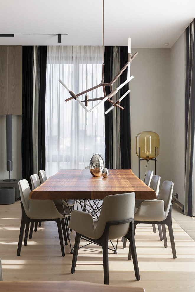 This is an example of a contemporary dining room in Saint Petersburg with beige walls and beige floor.