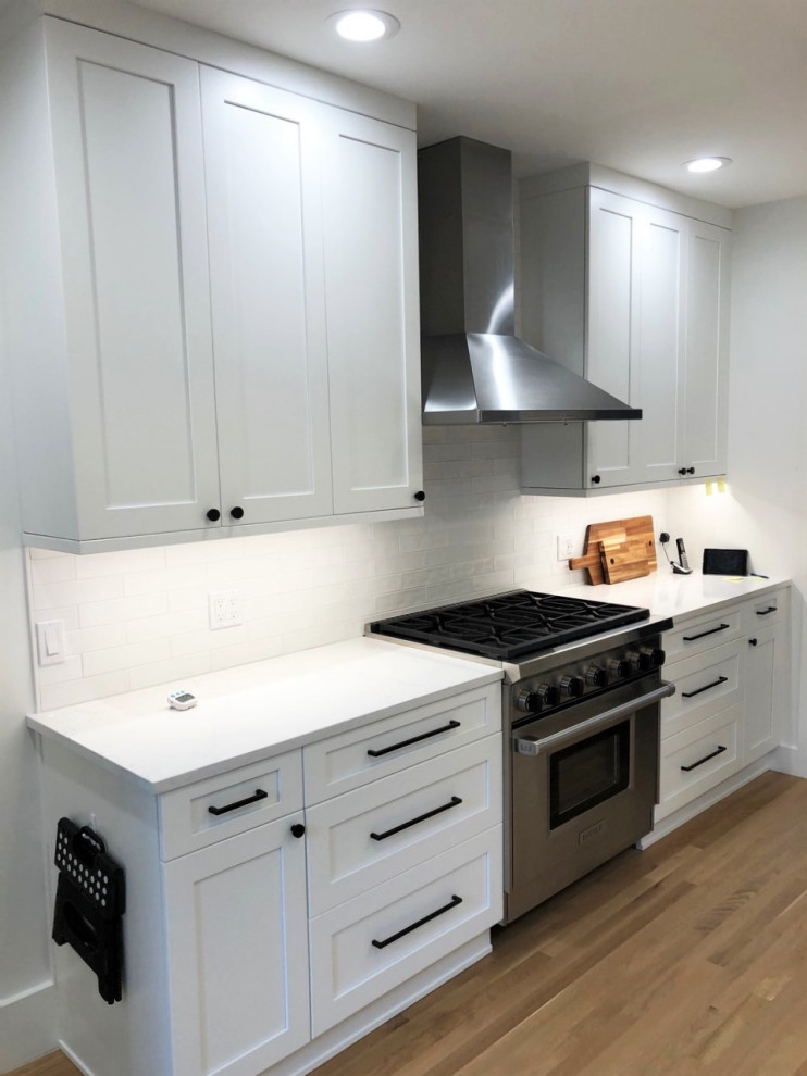 Mid-sized transitional u-shaped kitchen photo in Seattle with shaker cabinets, white cabinets, quartz countertops and white countertops