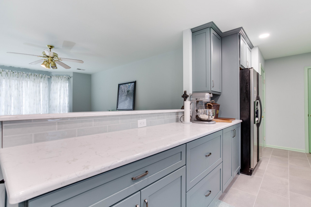 Design ideas for a large transitional galley eat-in kitchen in DC Metro with recessed-panel cabinets, blue cabinets, quartz benchtops, cement tile splashback, stainless steel appliances and no island.
