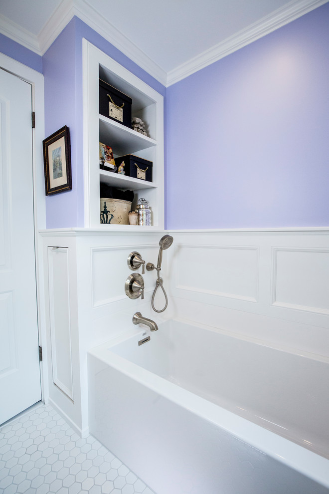 Photo of a small eclectic bathroom in Kansas City with furniture-like cabinets, white cabinets, an alcove tub, a two-piece toilet, purple walls, ceramic floors, a drop-in sink, onyx benchtops and white floor.