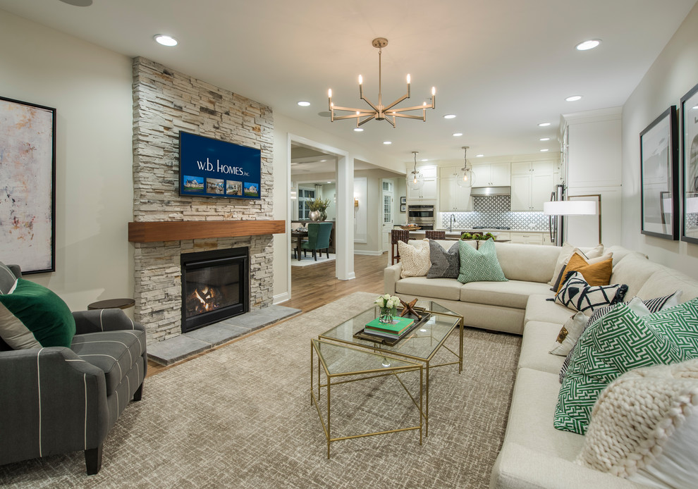 Design ideas for a transitional open concept family room in Philadelphia with light hardwood floors, a standard fireplace, a stone fireplace surround and a wall-mounted tv.