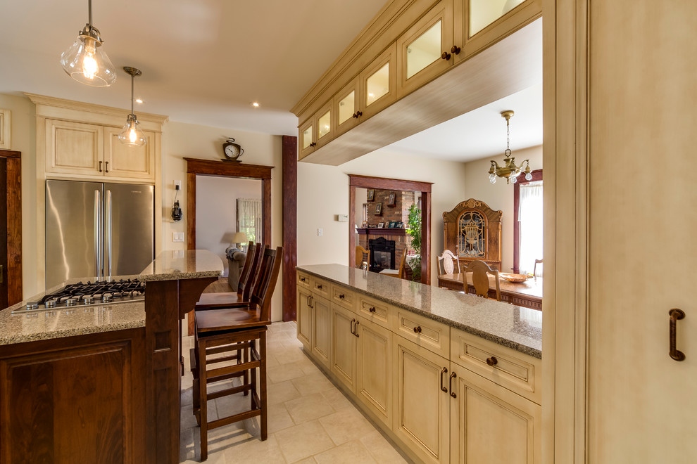 Photo of a mid-sized traditional u-shaped eat-in kitchen in Toronto with recessed-panel cabinets, distressed cabinets, granite benchtops, multi-coloured splashback, matchstick tile splashback, stainless steel appliances, ceramic floors and with island.