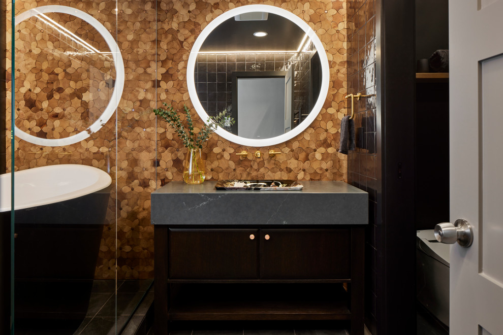 This is an example of a small eclectic master bathroom in Seattle with flat-panel cabinets, dark wood cabinets, a japanese tub, a shower/bathtub combo, a one-piece toilet, black tile, porcelain tile, black walls, slate floors, a drop-in sink, engineered quartz benchtops, grey floor, an open shower, grey benchtops, an enclosed toilet, a single vanity, a freestanding vanity and wood walls.