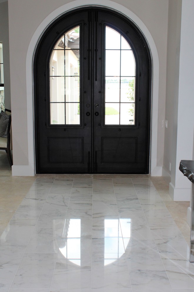 Inspiration for a large transitional foyer in Tampa with grey walls, travertine floors, a double front door, a dark wood front door and beige floor.