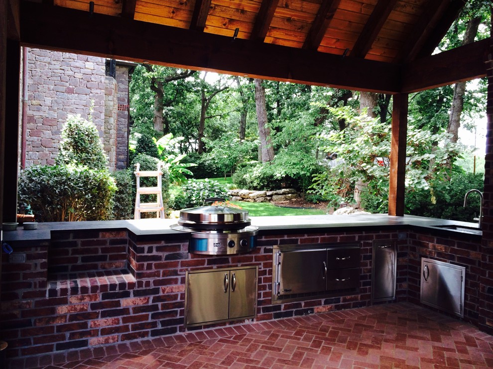 Inspiration for a mid-sized transitional backyard patio in Other with an outdoor kitchen, brick pavers and a roof extension.