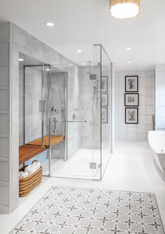 Photo of a large modern master bathroom in Chicago with a freestanding tub, a curbless shower, gray tile, porcelain tile, white walls, porcelain floors, white floor and a hinged shower door.