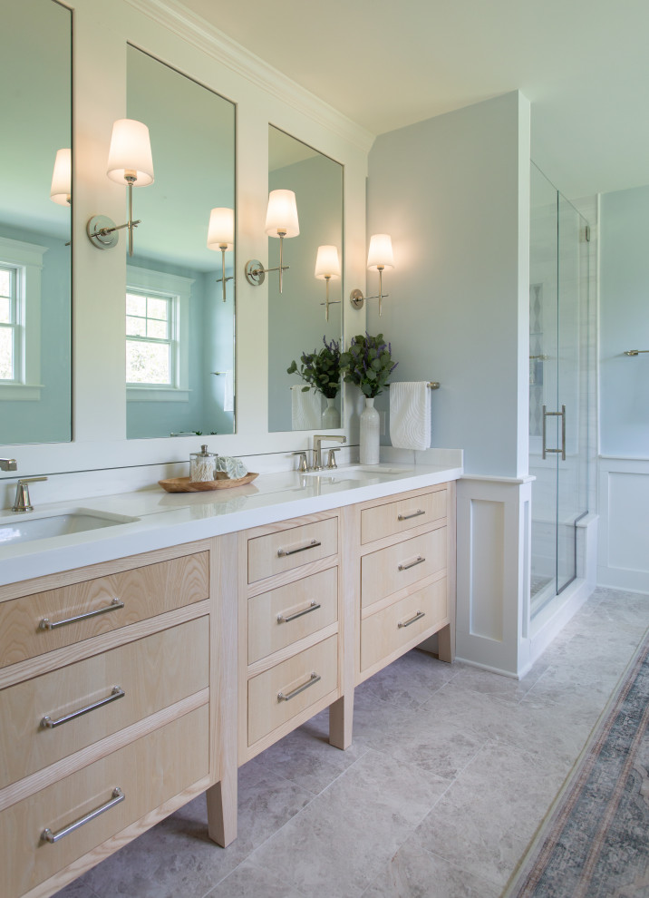 This is an example of a large traditional master bathroom in New York with flat-panel cabinets, light wood cabinets, marble benchtops, a double vanity and a built-in vanity.