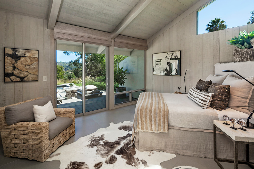 Large contemporary guest bedroom in Santa Barbara with grey walls, porcelain floors and no fireplace.
