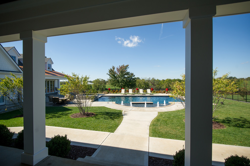 Example of a large transitional backyard concrete and rectangular pool house design