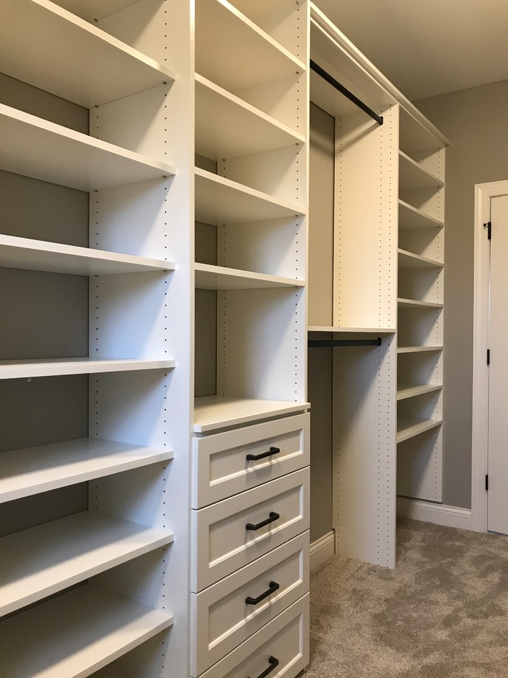 This is an example of a mid-sized contemporary gender-neutral walk-in wardrobe in Minneapolis with shaker cabinets, white cabinets, carpet and beige floor.
