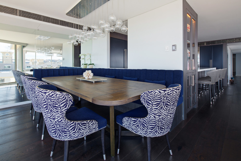 Photo of a large contemporary open plan dining in Sydney with white walls, dark hardwood floors and black floor.