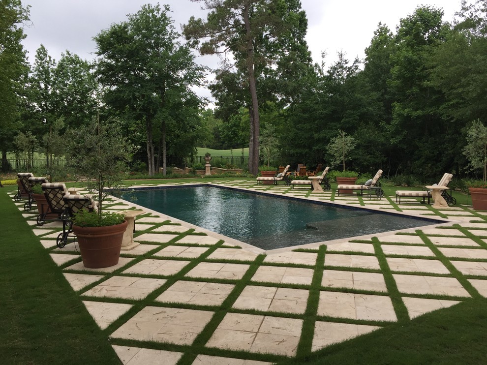 This is an example of a traditional backyard rectangular lap pool in Houston with tile.