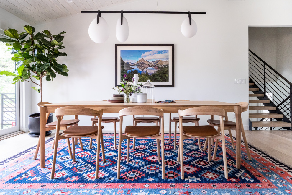 Design ideas for a scandi dining room in Denver with white walls, light hardwood flooring and beige floors.