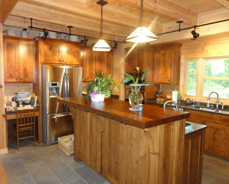 Kitchen - rustic ceramic tile kitchen idea with shaker cabinets, light wood cabinets, wood countertops and an island
