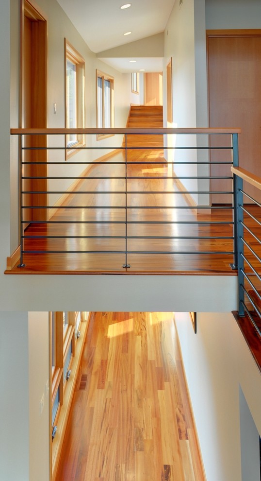 This is an example of a large contemporary hallway in Seattle with white walls and medium hardwood floors.