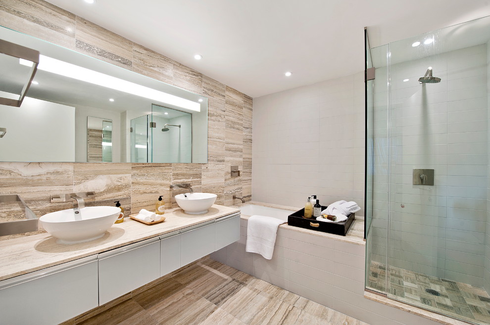 Modern bathroom in New York with stone tile and a vessel sink.