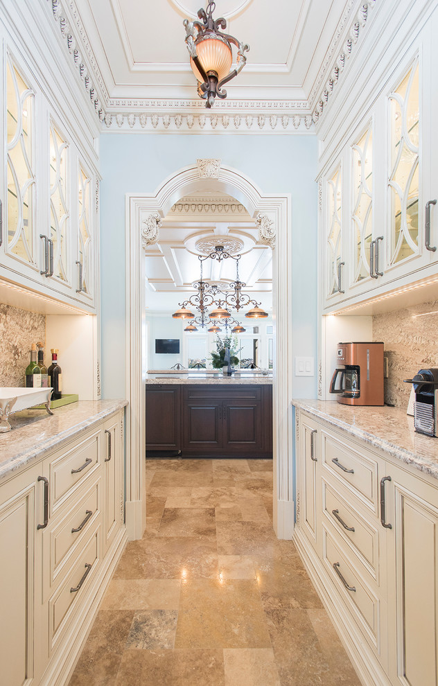 Inspiration for an expansive traditional l-shaped kitchen pantry in New York with an undermount sink, raised-panel cabinets, white cabinets, marble benchtops, multi-coloured splashback, mosaic tile splashback, stainless steel appliances, marble floors, multiple islands, beige floor and beige benchtop.