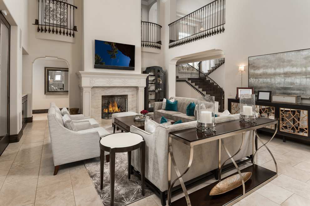 Inspiration for an expansive mediterranean open concept family room in Phoenix with white walls, marble floors, a standard fireplace, a stone fireplace surround, no tv, multi-coloured floor, coffered and panelled walls.