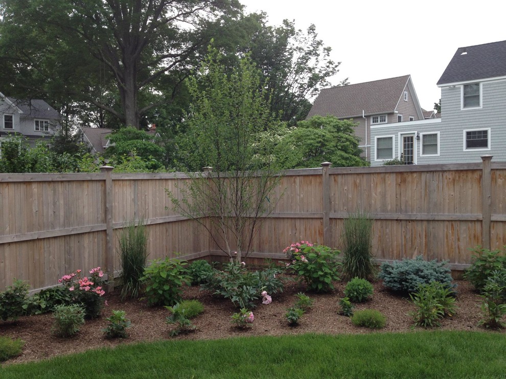 This is an example of a transitional backyard formal garden in New York.