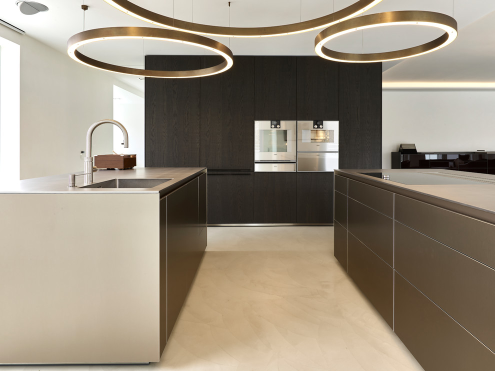 Design ideas for a mid-sized modern u-shaped open plan kitchen in Munich with an integrated sink, flat-panel cabinets, brown cabinets, stainless steel appliances, concrete floors, multiple islands and beige floor.
