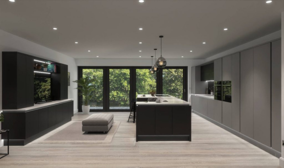 Contemporary galley open plan kitchen in Hertfordshire with flat-panel cabinets, an island and feature lighting.