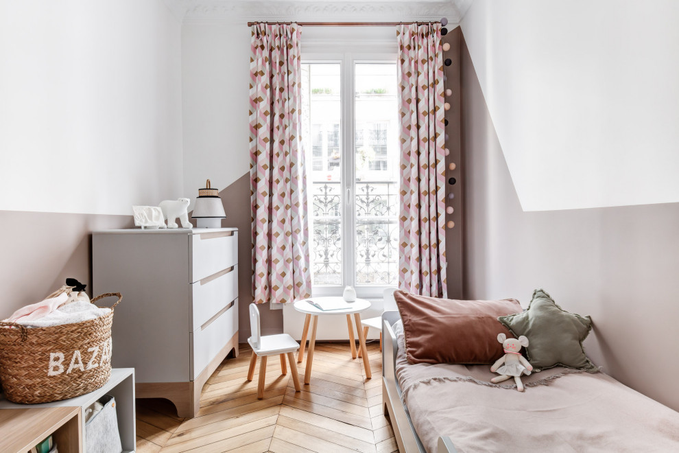Inspiration pour une chambre d'enfant de 1 à 3 ans minimaliste de taille moyenne avec un mur rose, parquet clair et un sol beige.