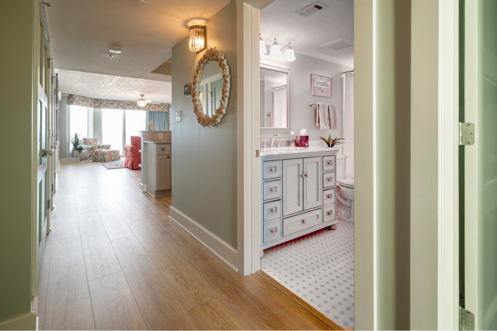 This is an example of a beach style hallway in Wilmington with vinyl floors, yellow floor and green walls.