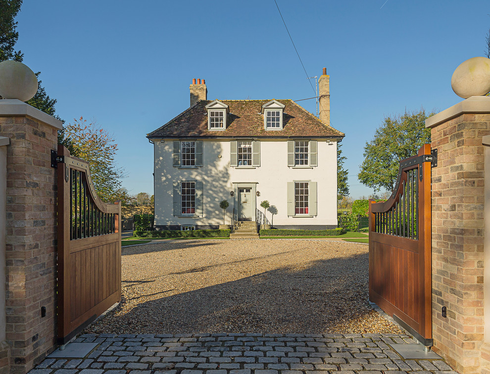 Large traditional two-storey white house exterior in Cambridgeshire with a hip roof.