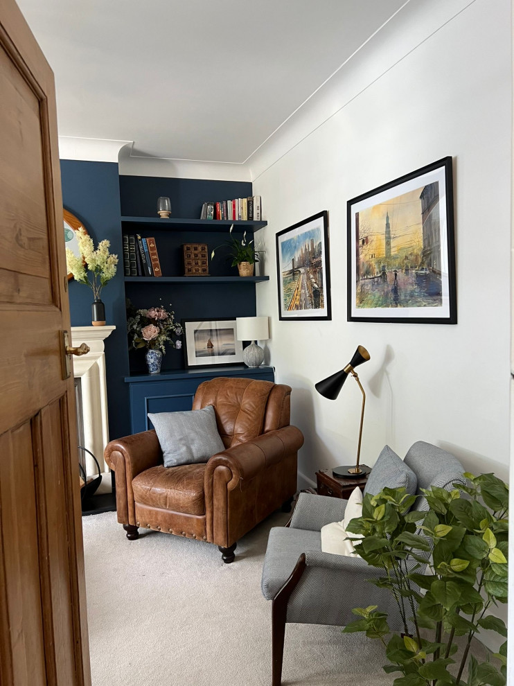 This is an example of a medium sized traditional formal enclosed living room in London with blue walls, carpet, a wood burning stove, a stone fireplace surround, a built-in media unit, beige floors and feature lighting.