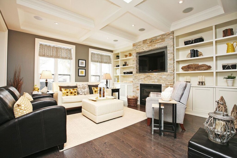 Photo of a large transitional open concept family room in Toronto with grey walls, dark hardwood floors, a standard fireplace, a stone fireplace surround, a wall-mounted tv and brown floor.
