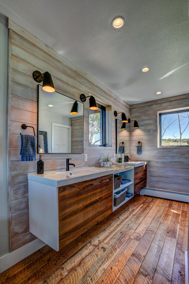 Design ideas for a country master bathroom in Denver with flat-panel cabinets, brown tile, brown walls, wood-look tile, an integrated sink, brown floor, a double vanity, a floating vanity and wood walls.