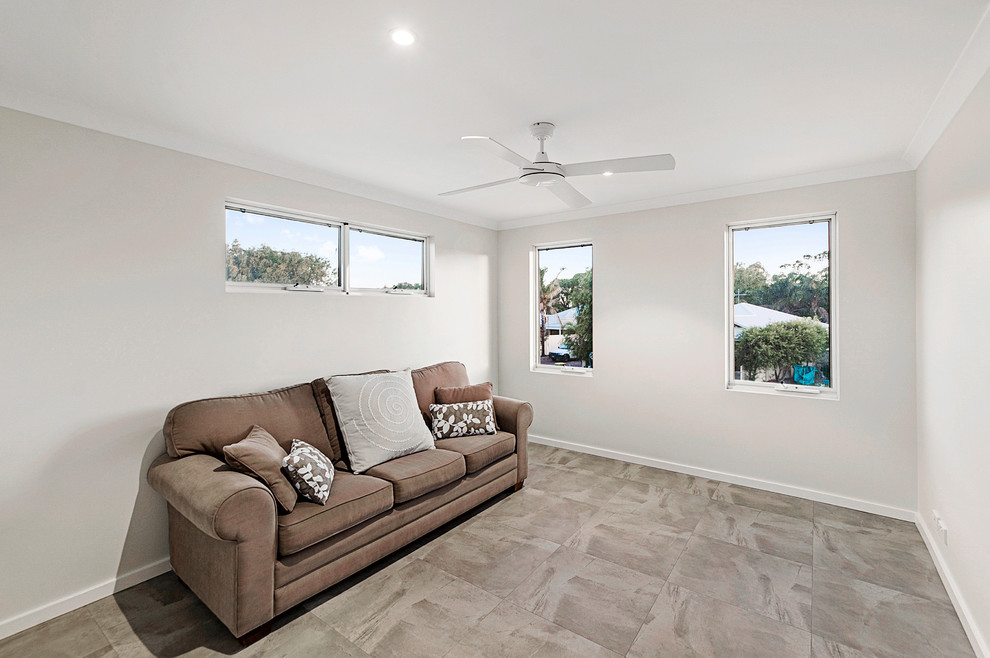 Beach style family room in Perth.