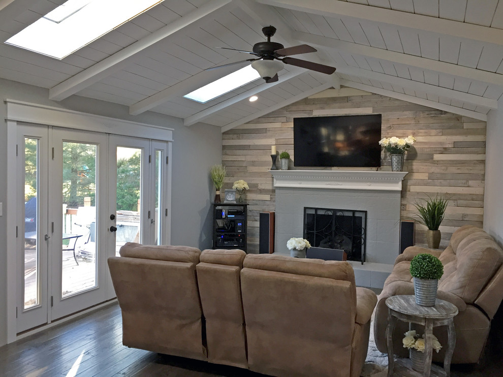 Inspiration for a country open concept living room in Philadelphia with grey walls, dark hardwood floors, a standard fireplace, a tile fireplace surround and a wall-mounted tv.