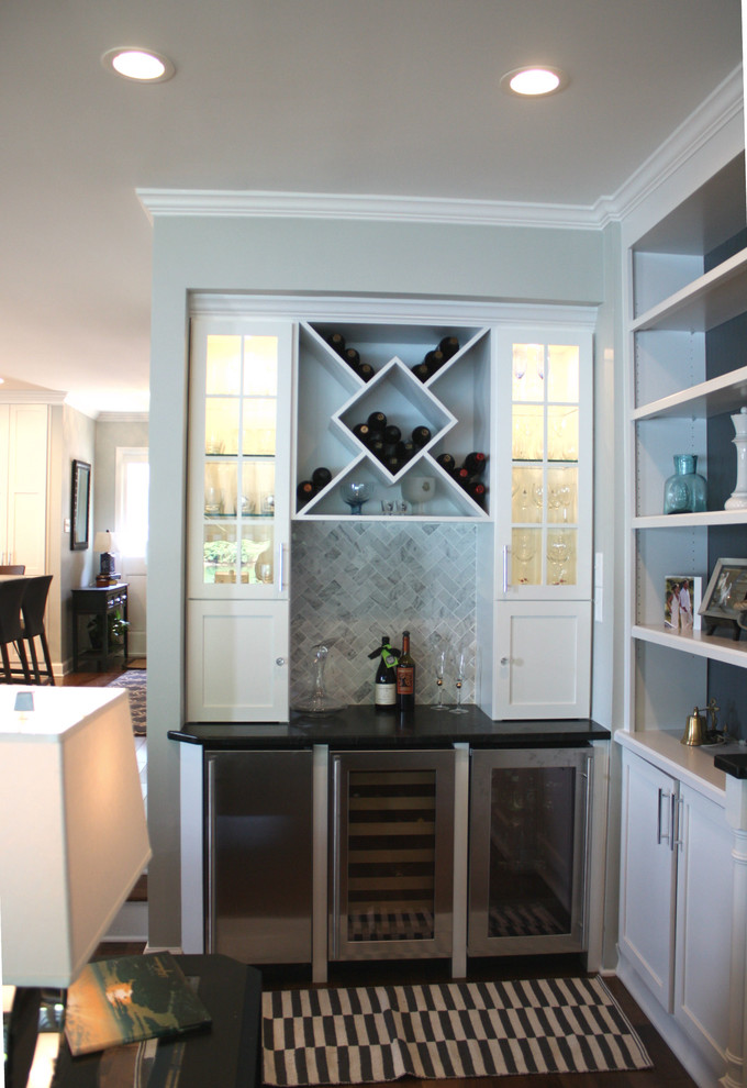Photo of a mid-sized beach style home bar in Charlotte with marble splashback.