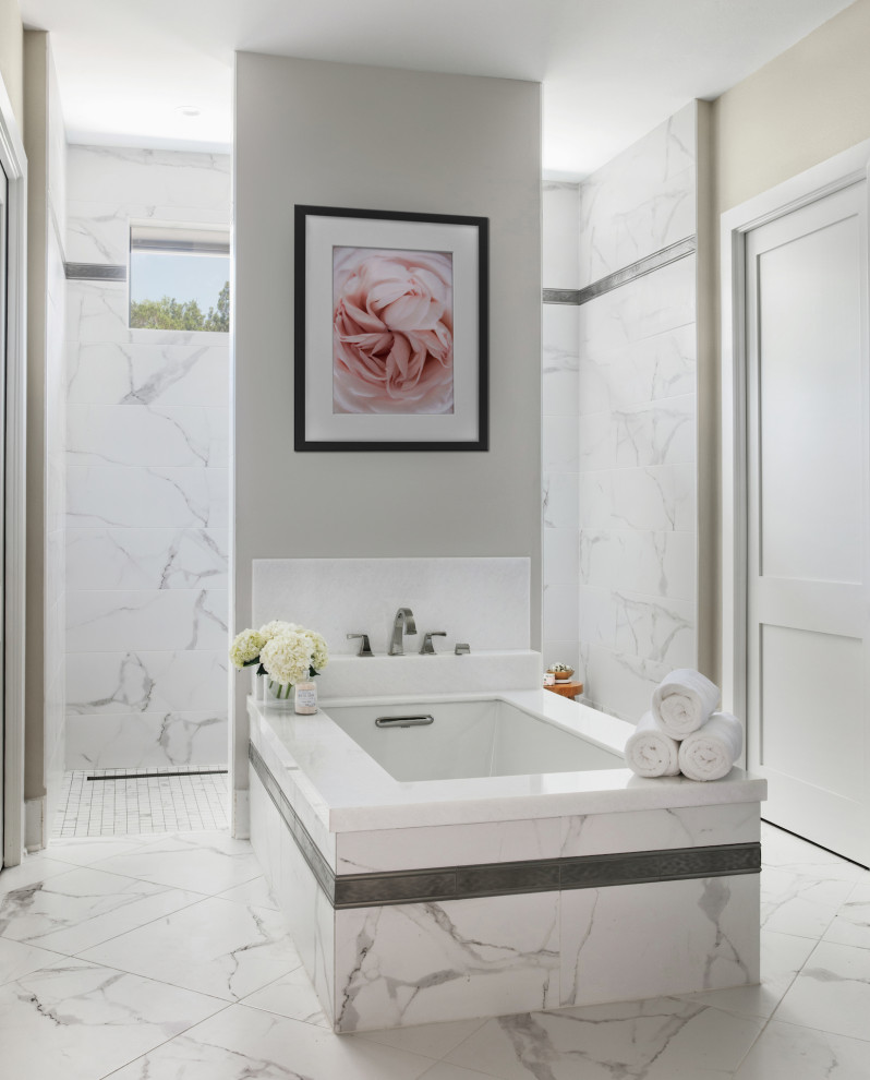 This is an example of a large transitional master bathroom in Austin with shaker cabinets, grey cabinets, an undermount tub, an open shower, white tile, porcelain tile, beige walls, porcelain floors, an undermount sink, granite benchtops, white floor, an open shower, white benchtops, a single vanity and a built-in vanity.