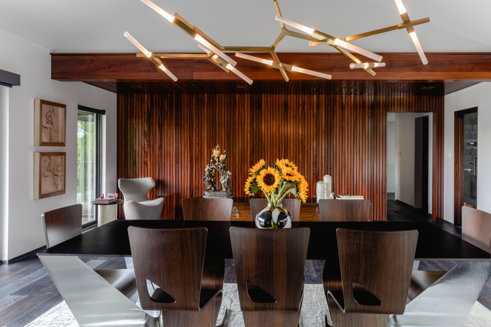 Expansive contemporary kitchen/dining combo in Philadelphia with concrete floors, a two-sided fireplace, a stone fireplace surround, multi-coloured floor, vaulted and wood walls.