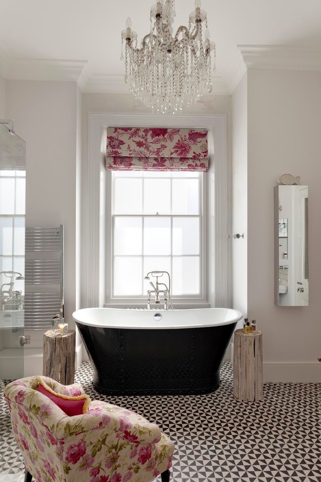Photo of a traditional master bathroom in Sussex with a freestanding tub and grey walls.