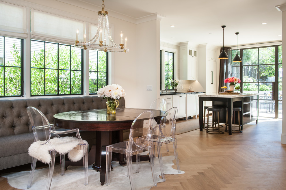 Photo of a mid-sized transitional open plan dining in San Francisco with white walls, light hardwood floors and brown floor.