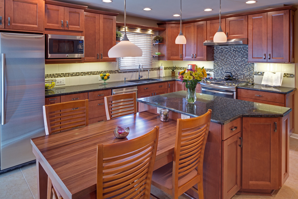 Kitchen - mid-sized transitional l-shaped porcelain tile kitchen idea in Chicago with an undermount sink, recessed-panel cabinets, medium tone wood cabinets, quartz countertops, white backsplash, mosaic tile backsplash and stainless steel appliances