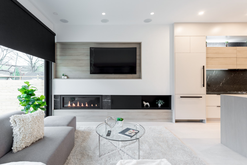 Photo of a mid-sized modern formal open concept living room in Toronto with white walls, a ribbon fireplace, a metal fireplace surround, a wall-mounted tv, beige floor and light hardwood floors.