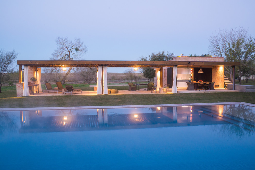 Contemporary pool in Austin with natural stone pavers.