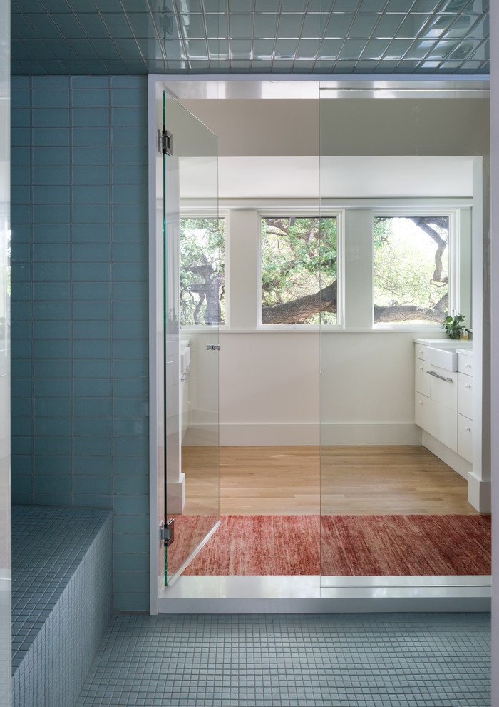 Photo of a transitional bathroom in Austin with flat-panel cabinets.
