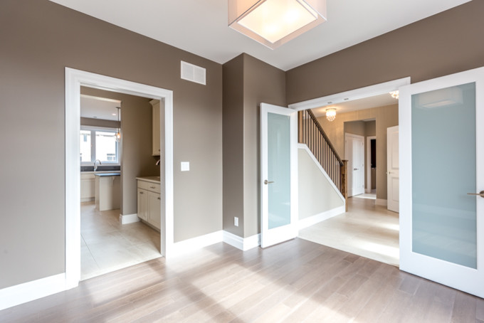 Mid-sized transitional study room in Toronto with brown walls and medium hardwood floors.
