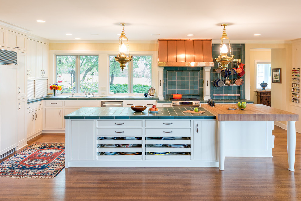 Photo of a large traditional l-shaped eat-in kitchen in Minneapolis with an undermount sink, shaker cabinets, white cabinets, tile benchtops, blue splashback, panelled appliances, medium hardwood floors, with island, ceramic splashback and turquoise benchtop.