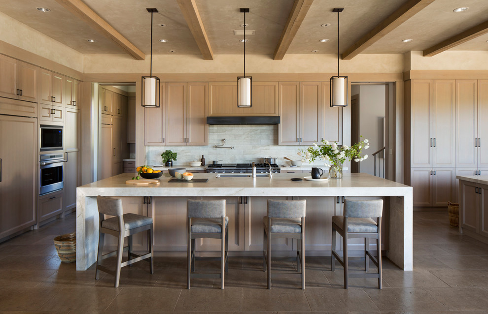 This is an example of a transitional kitchen in San Francisco with an undermount sink, recessed-panel cabinets, light wood cabinets, beige splashback, stainless steel appliances and with island.