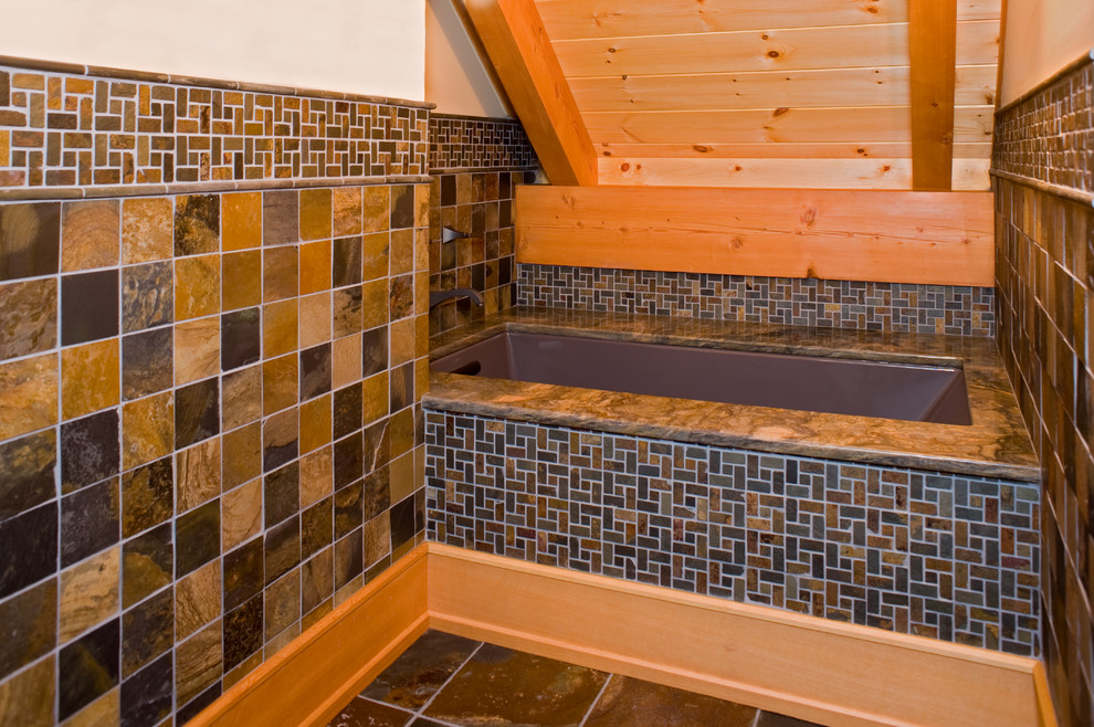 Large mountain style master gray tile and slate tile slate floor alcove shower photo with flat-panel cabinets, medium tone wood cabinets, an undermount tub, white walls and a vessel sink