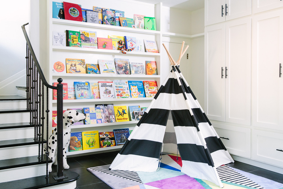 Photo of a transitional gender-neutral kids' playroom in Austin with white walls, slate floors and black floor.
